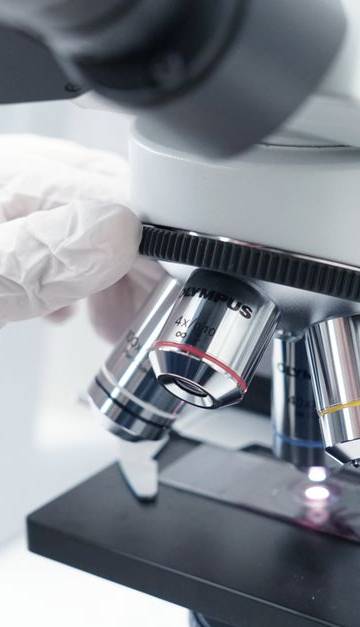 A detailed view of a microscope being used in a modern laboratory.