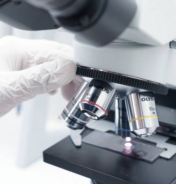 A detailed view of a microscope being used in a modern laboratory.
