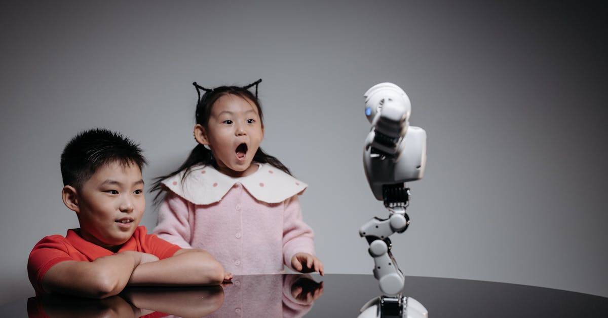 Two children fascinated by a toy robot, showcasing excitement and curiosity indoors.