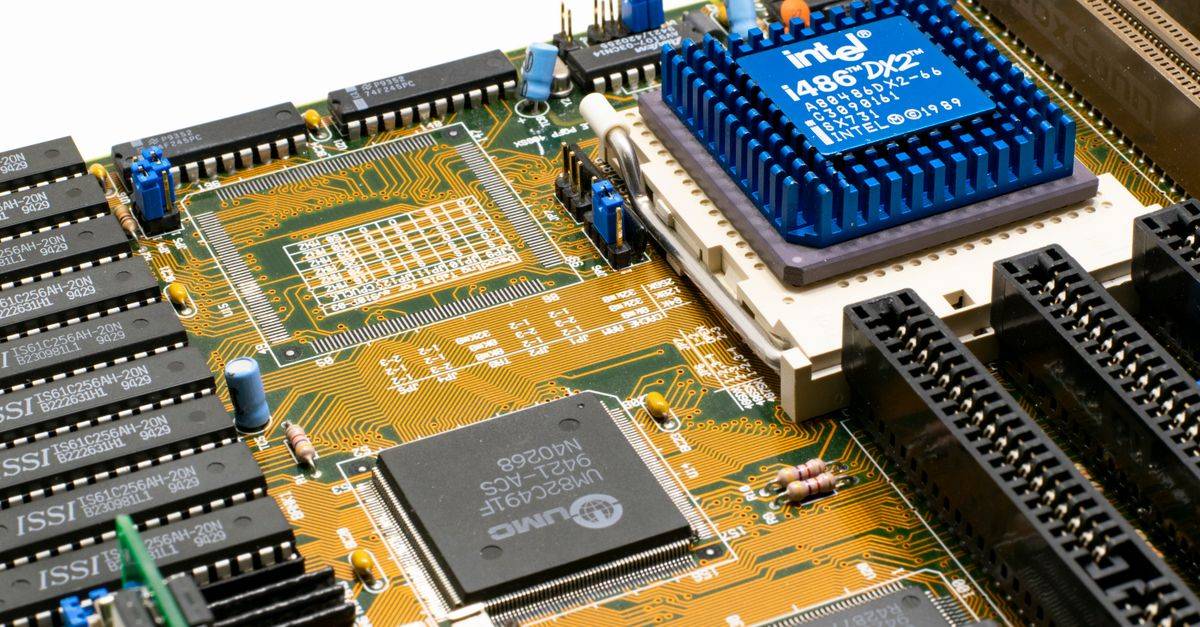 Detailed view of an Intel i486 DX2 CPU installed on a vintage motherboard with chips and circuits.