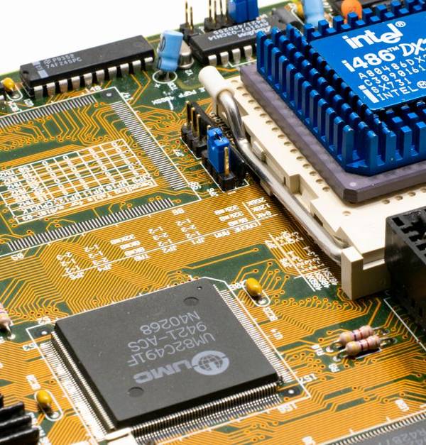 Detailed view of an Intel i486 DX2 CPU installed on a vintage motherboard with chips and circuits.