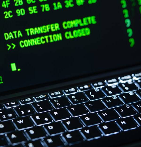Close-up of a laptop screen displaying green code text. Perfect for cybersecurity themes.