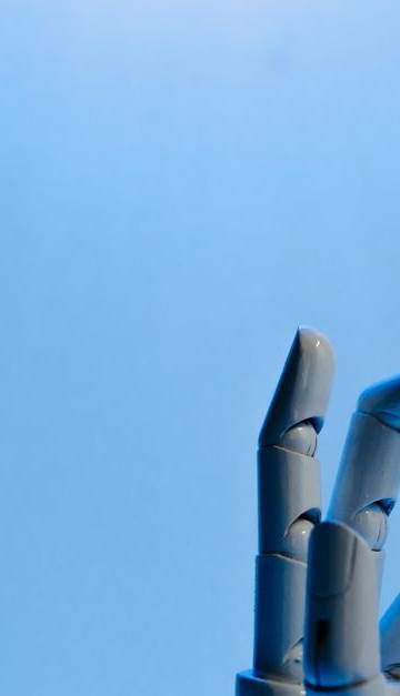 Robotic hand with articulated fingers reaching towards the sky on a blue background.