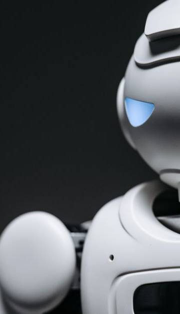High-tech robot toy with a gray background in studio lighting.