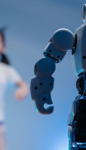 A young girl playfully interacts with a humanoid robot in a futuristic indoor environment featuring soft blue lighting.