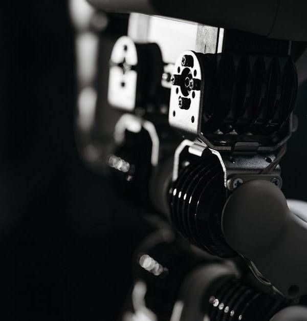 Detailed close-up of a robot's mechanical components, emphasized by moody studio lighting.