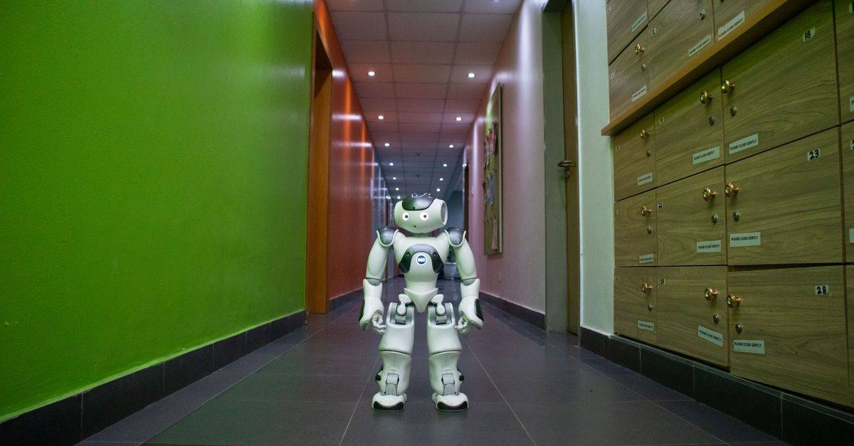 A humanoid robot stands in a vibrant, modern hallway in Lagos, Nigeria.