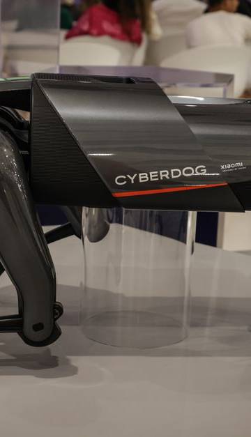 A futuristic robot dog, the Cyberdog, on display in an indoor setting, showcasing advanced robotics technology.