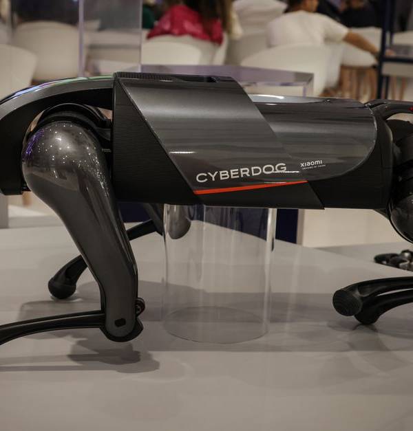 A futuristic robot dog, the Cyberdog, on display in an indoor setting, showcasing advanced robotics technology.