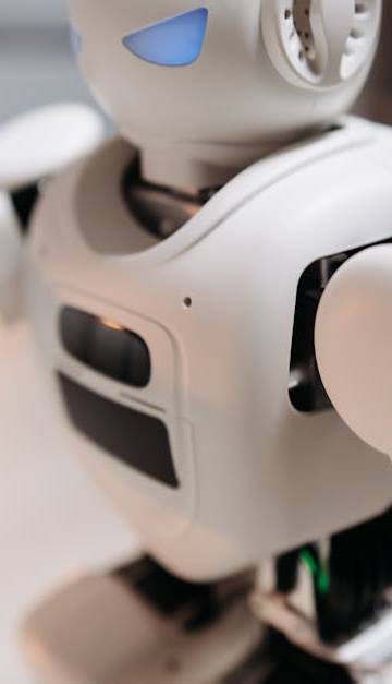 Close-up of a futuristic toy robot with blue eyes, showcasing modern technology indoors.