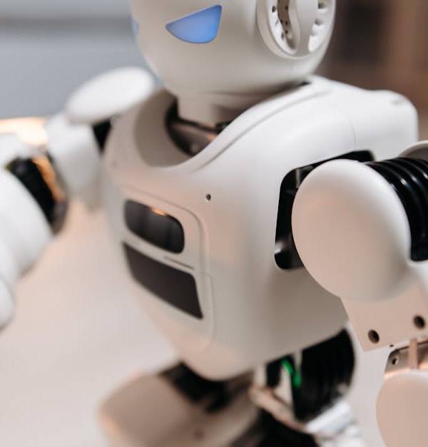 Close-up of a futuristic toy robot with blue eyes, showcasing modern technology indoors.