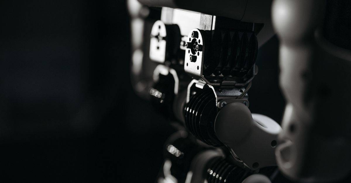 Detailed close-up of a robot's mechanical components, emphasized by moody studio lighting.