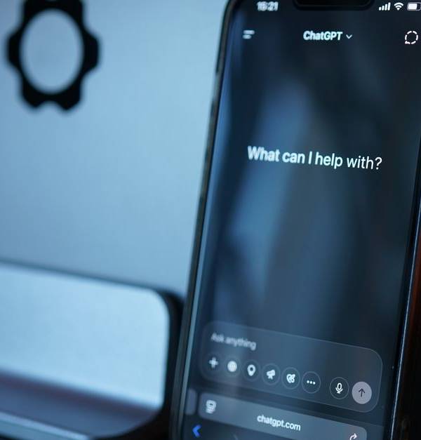 Close-up of a smartphone with AI chat interface, showcasing advanced technology in a sleek design.