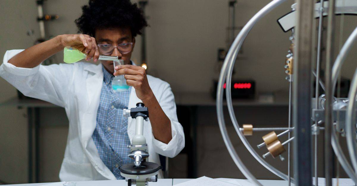 A scientist experiments with chemicals in a laboratory, making scientific discoveries.