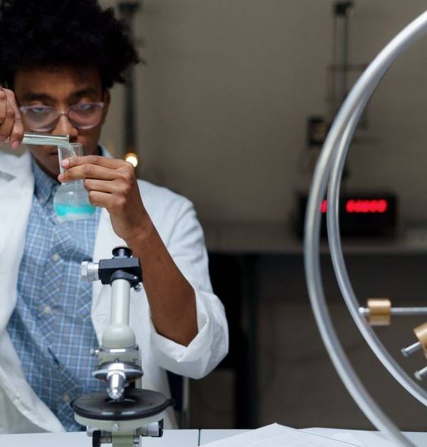 A scientist experiments with chemicals in a laboratory, making scientific discoveries.