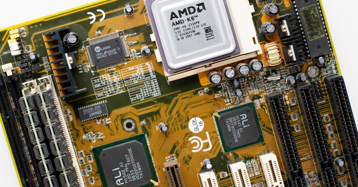 Close-up of a vintage AMD K6 CPU on a retro motherboard showing intricate electronic details.
