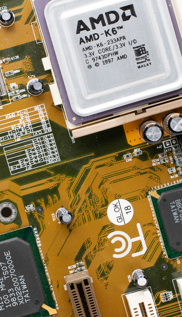 Close-up of a vintage AMD K6 CPU on a retro motherboard showing intricate electronic details.