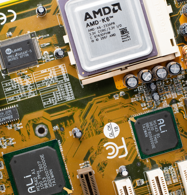 Close-up of a vintage AMD K6 CPU on a retro motherboard showing intricate electronic details.
