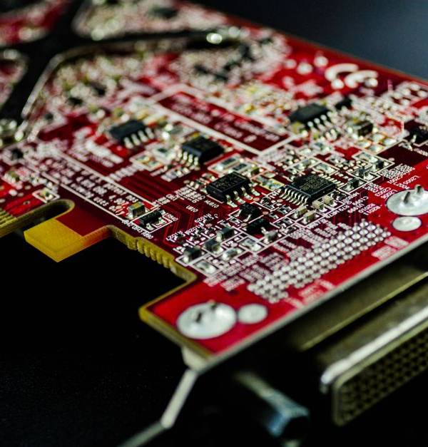 Detailed close-up of a red circuit board highlighting electronic components and connectors.