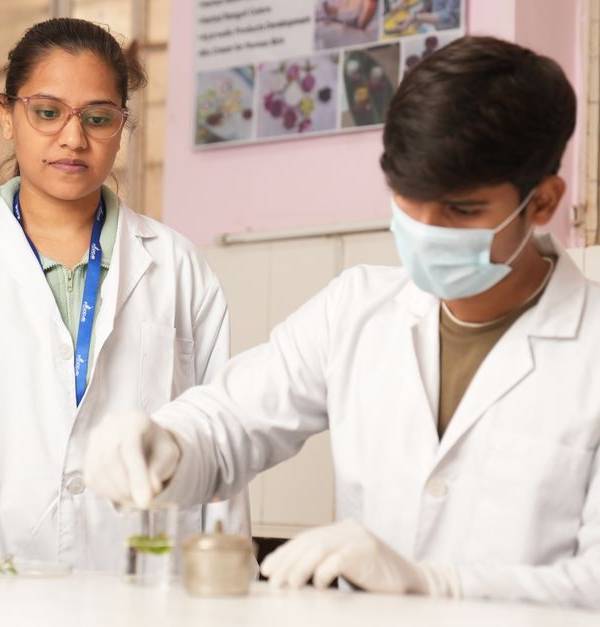Two young scientists in lab coats performing an experiment in a laboratory setting.