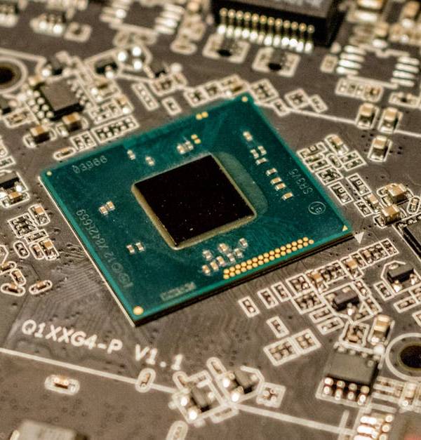Detailed view of a microchip on a printed circuit board, showcasing electronic components.