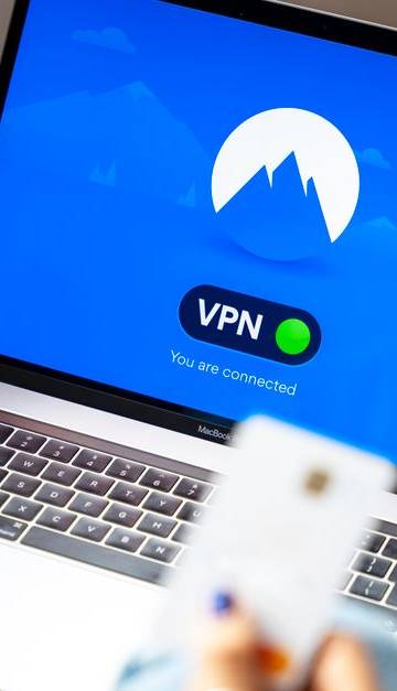 A person using a VPN on a laptop, symbolizing secure internet browsing in a modern indoor setting.