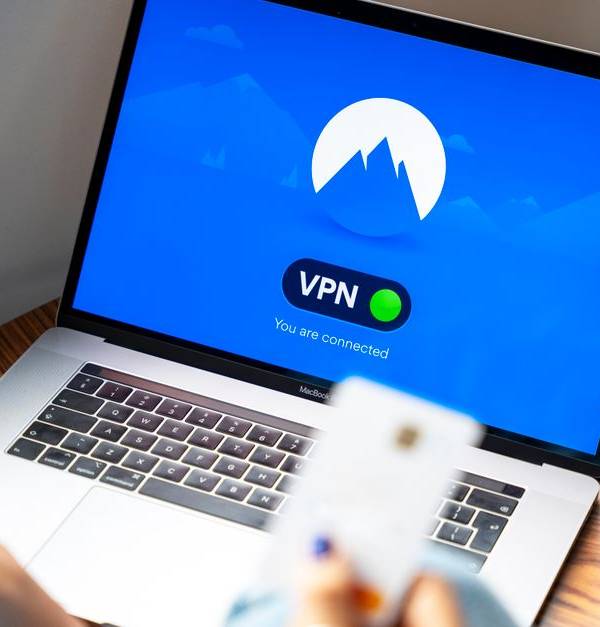 A person using a VPN on a laptop, symbolizing secure internet browsing in a modern indoor setting.
