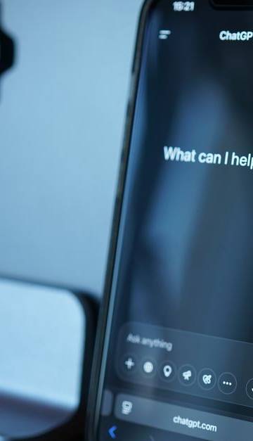 Close-up of a smartphone with AI chat interface, showcasing advanced technology in a sleek design.