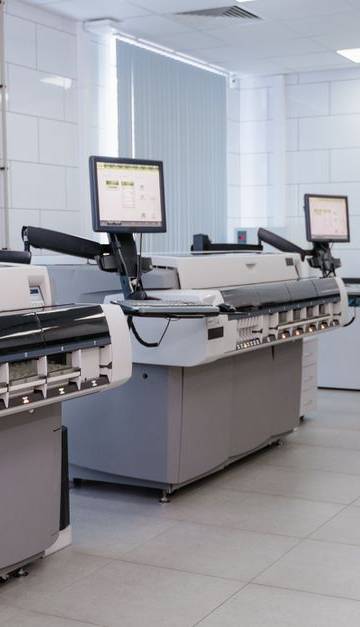 Spacious laboratory interior featuring state-of-the-art machines and computers for research purposes.