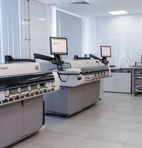 Spacious laboratory interior featuring state-of-the-art machines and computers for research purposes.