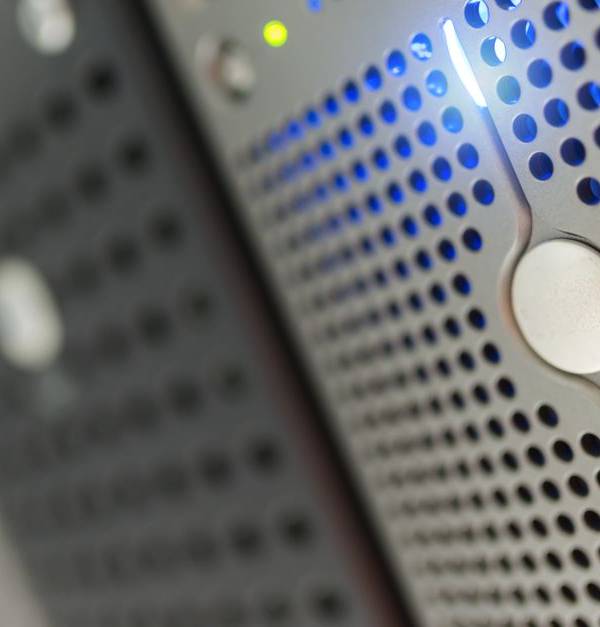 Focused detail of a modern server rack with blue LED indicators in a data center.