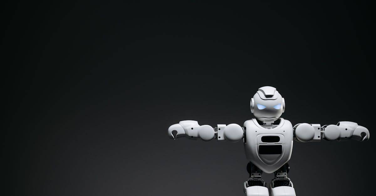 Studio shot of a humanoid robot with glowing eyes against a dark background, offering ample copyspace.