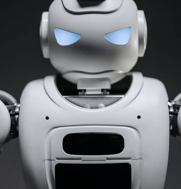 Detailed studio shot of a modern robotic toy with a dark background, showcasing technological design.
