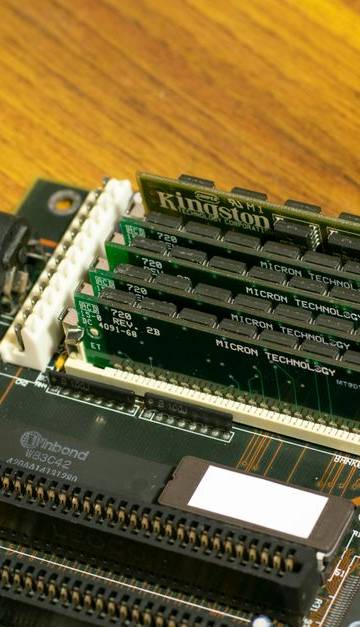 Detailed image of a vintage computer motherboard with RAM sticks.