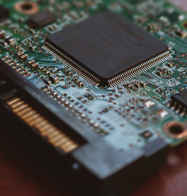 Detailed shot of a computer circuit board showing components and golden pins.