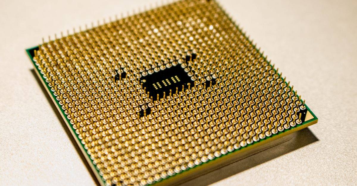 Detailed close-up of a golden microprocessor chip, ideal for technology concepts.