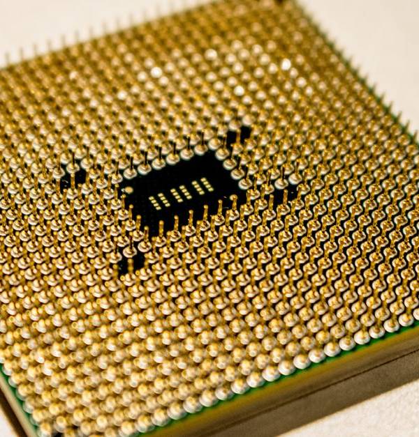 Detailed close-up of a golden microprocessor chip, ideal for technology concepts.