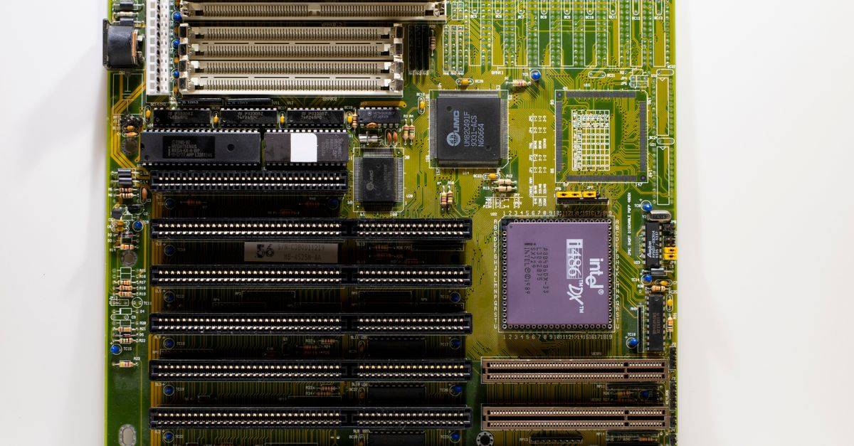 Close-up of a vintage motherboard showcasing Intel microprocessor and slots for hardware integration.