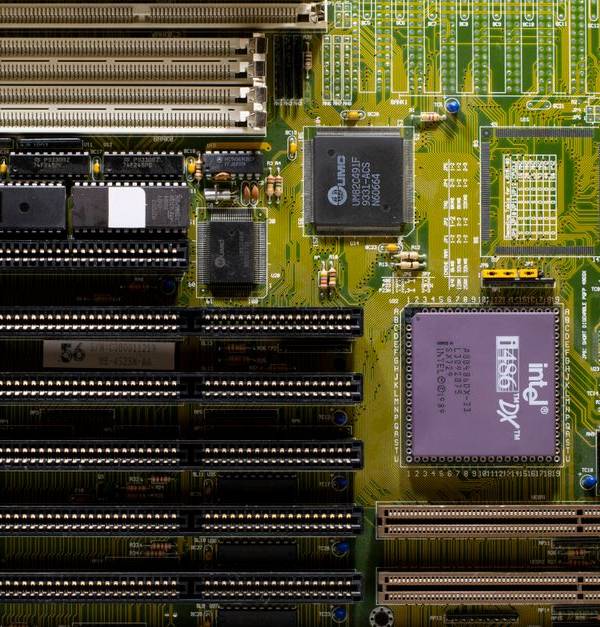 Close-up of a vintage motherboard showcasing Intel microprocessor and slots for hardware integration.