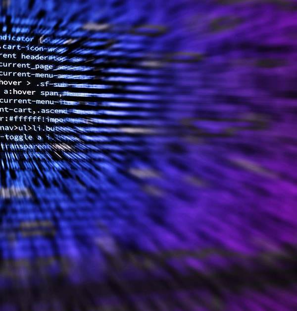 Dynamic abstract background featuring computer code in focus with blurred effect.