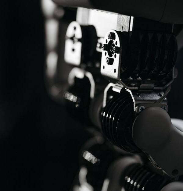 Detailed close-up of a robot's mechanical components, emphasized by moody studio lighting.
