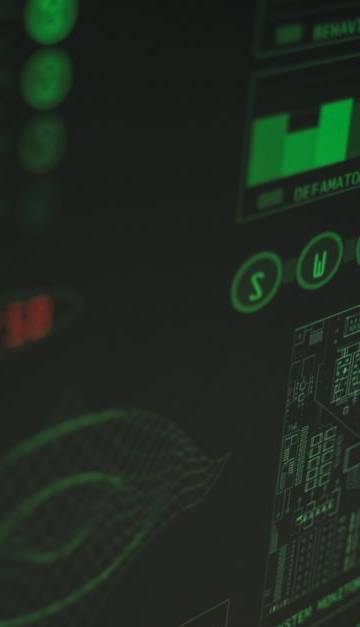 Close-up view of a computer displaying cybersecurity and data protection interfaces in green tones.