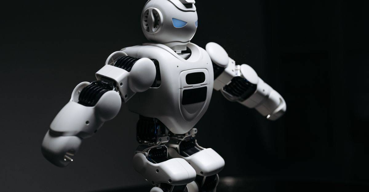 Close-up of a futuristic humanoid robot under dramatic lighting in dark ambiance.