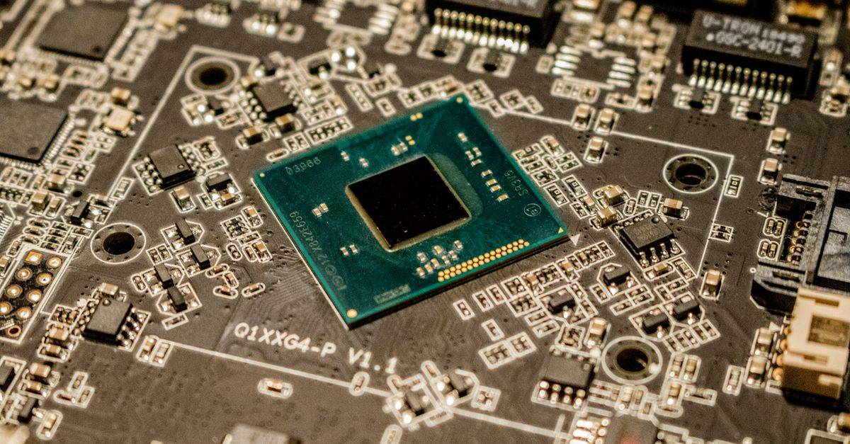 Detailed view of a microchip on a printed circuit board, showcasing electronic components.