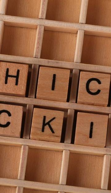 Wooden blocks spell 'ethical hacking', symbolizing cybersecurity concepts.
