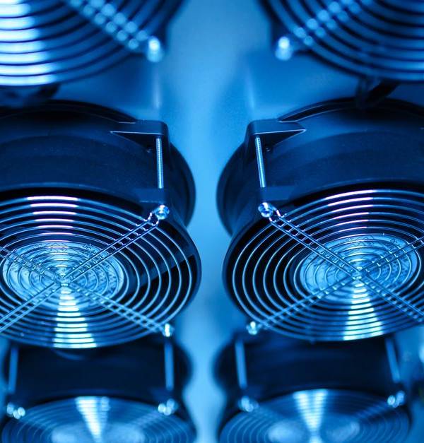 Close-up of cooling fans in a server room, showcasing technology and efficiency.