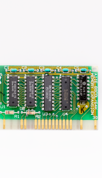 A close-up of a vintage circuit board with microchips, showcasing retro technology and design.
