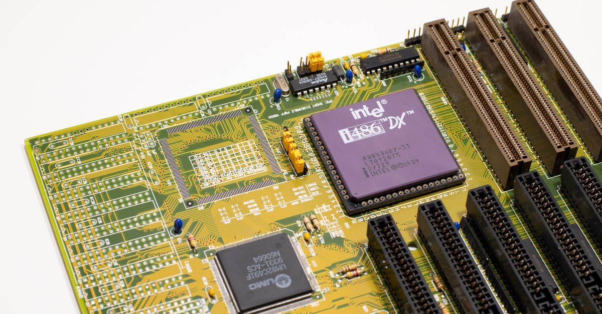 Close-up of a vintage Intel 486 CPU motherboard with PCI slots, highlighting retro technology components.