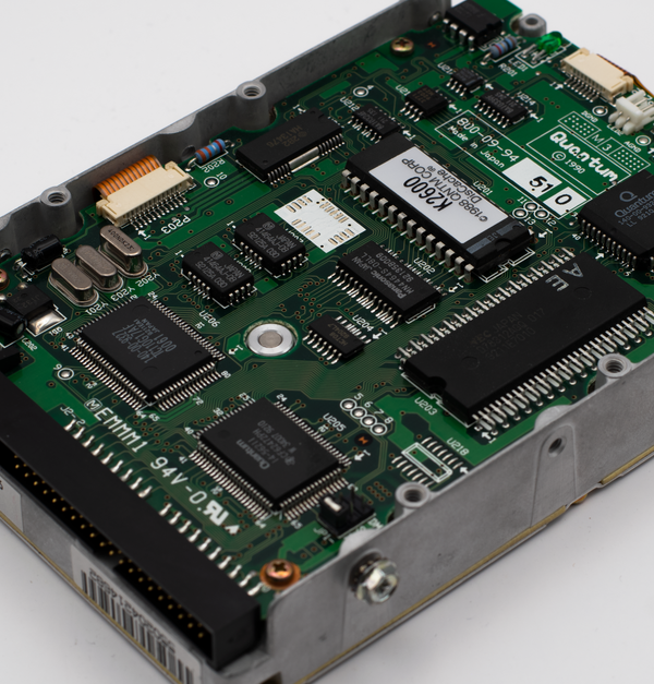 Close-up of a vintage hard drive circuit board showcasing intricate electronic components.