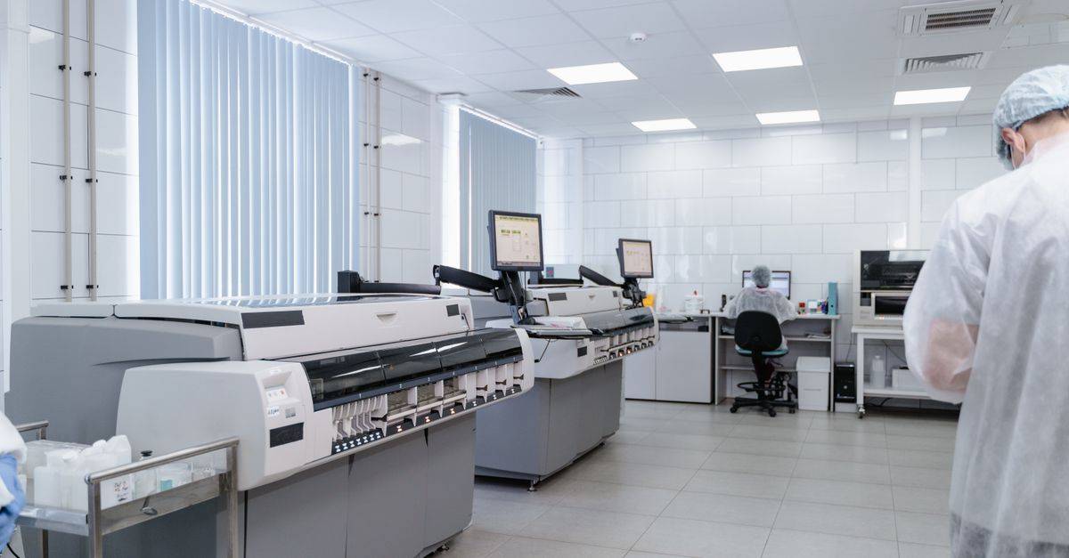 Bright and sterile laboratory featuring high-tech research equipment and professionals at work.